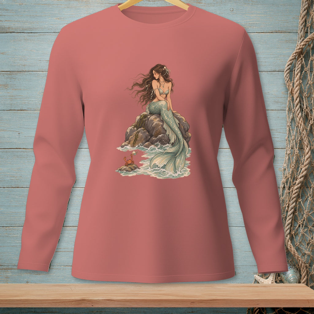 Mermaid with a crab on a rock by the sea, printed on a pink long-sleeved shirt.