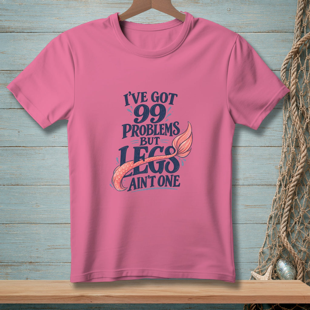 Pink t-shirt with "I've got 99 problems but legs ain't one" text and mermaid tail.