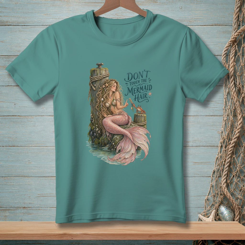 Mermaid sitting on dock with crab, text "Don't touch the mermaid hair".