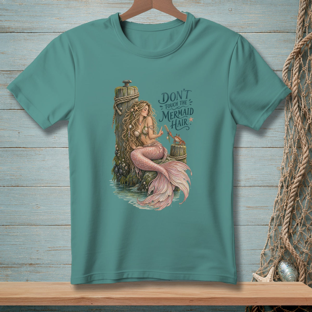 Mermaid sitting on dock with crab, text "Don't touch the mermaid hair".