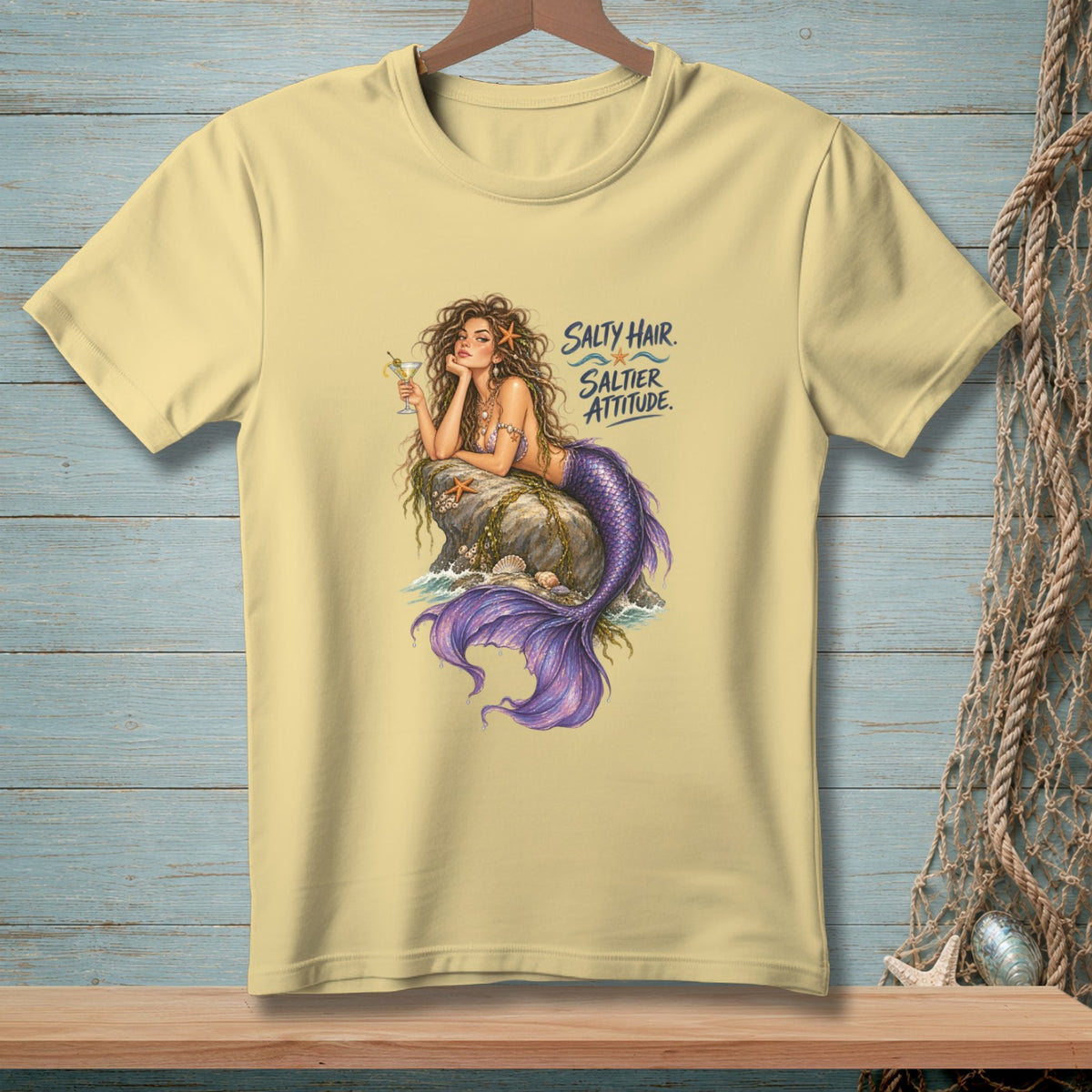 Light yellow t-shirt with mermaid art and text "Salty Hair. Saltier Attitude."