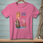 Pink t-shirt with a cartoon mermaid and crab, reading "Talk to the tail, crabcake."