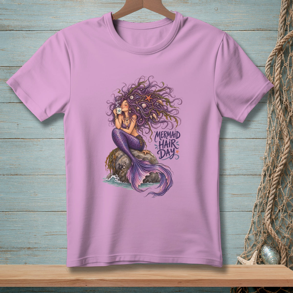 Purple t-shirt with a mermaid illustration holding a cup and text "Mermaid Hair Day".