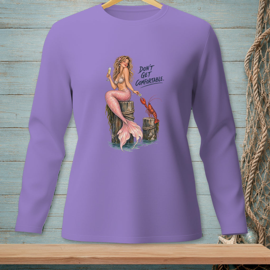 Purple long-sleeve shirt with a mermaid, lobster, champagne, and text "DON'T GET COMFORTABLE."