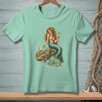 Mint t-shirt with a detailed illustration of a mermaid holding a drink and a crab on a rock.