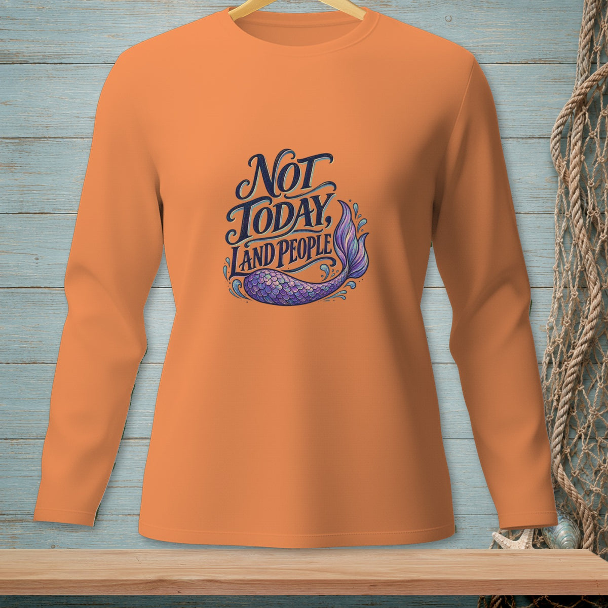 Orange long-sleeve shirt with "Not Today, Land People" text and a mermaid tail graphic.