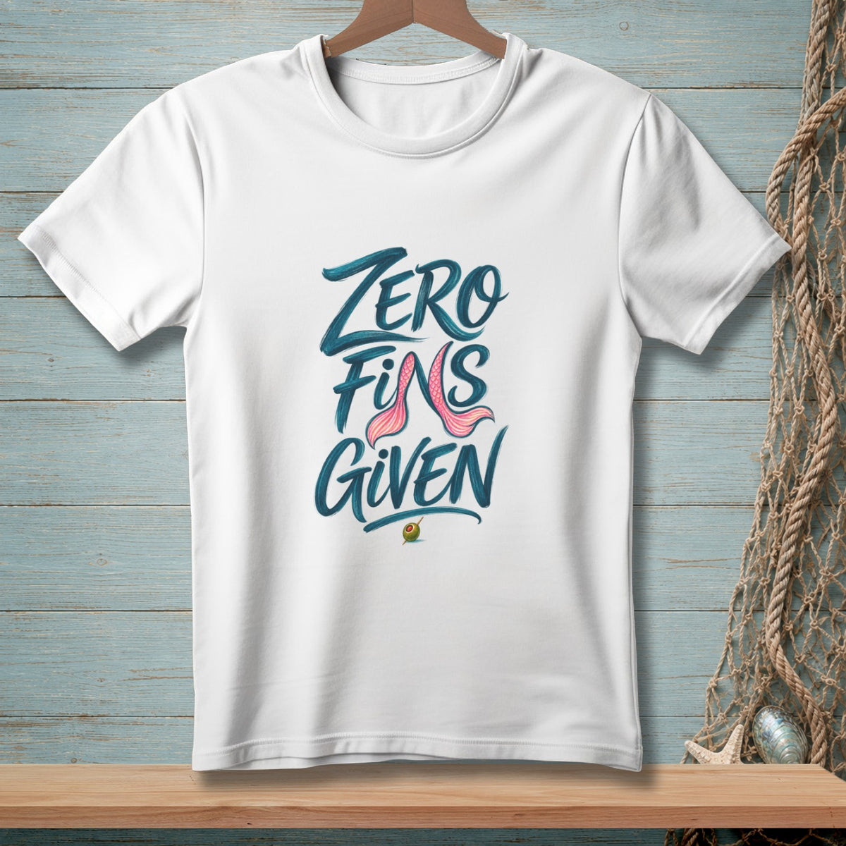 White t-shirt with "Zero Fins Given" text and pink mermaid fins graphic.
