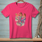 Three mermaids with champagne glasses sit in water on a pink t-shirt.