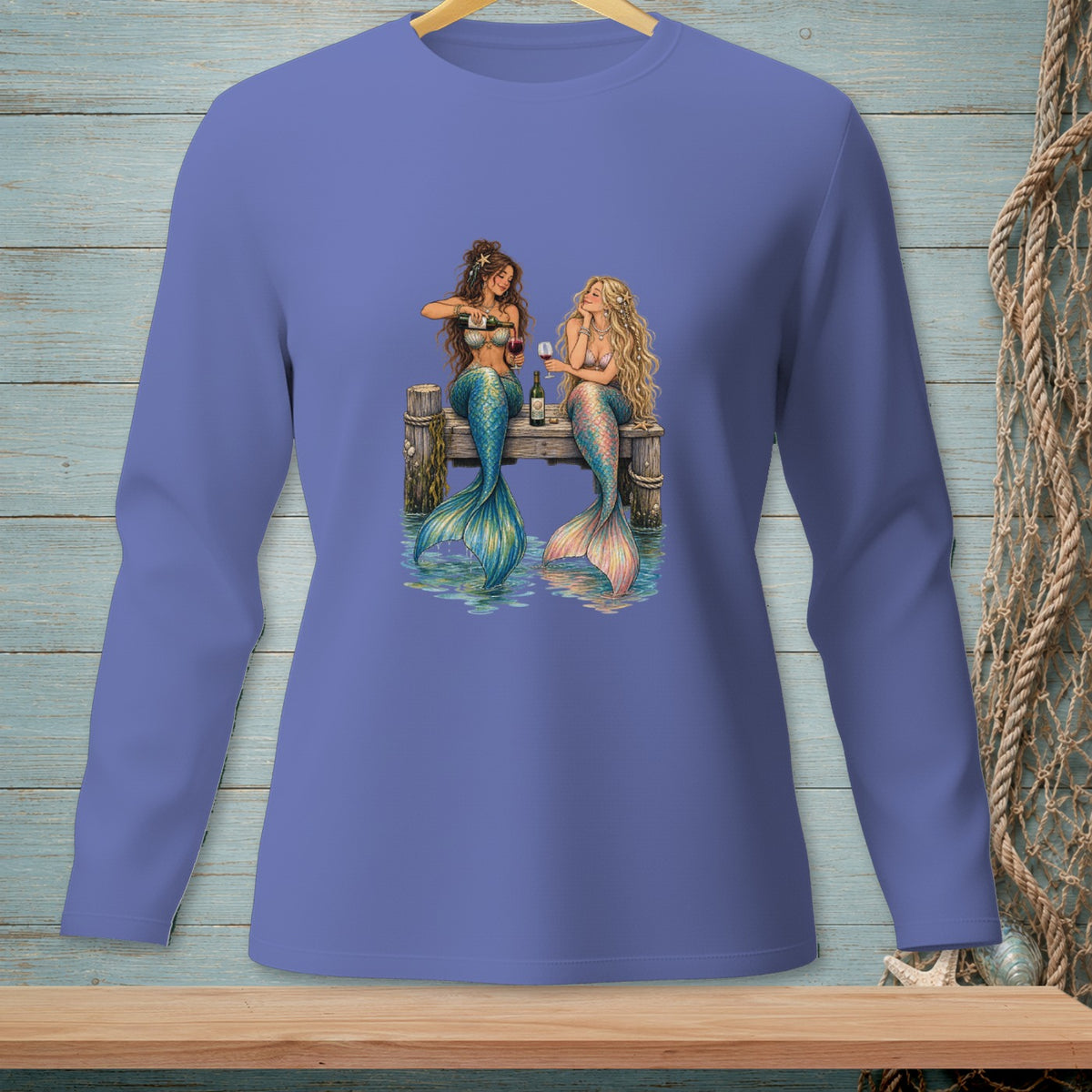 Two mermaids sitting on a dock, one pouring wine for another.