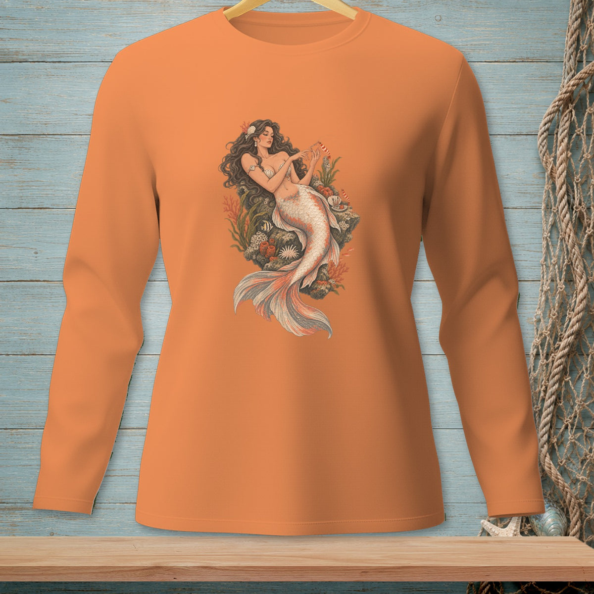 Orange long-sleeve shirt featuring a detailed illustration of a mermaid with a pearl tail.