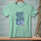 Light mint t-shirt with "Don't Test The Waters" text, mermaid tail, and crab graphic.