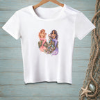 White t-shirt with two mermaids sitting on rocks surrounded by treasures.
