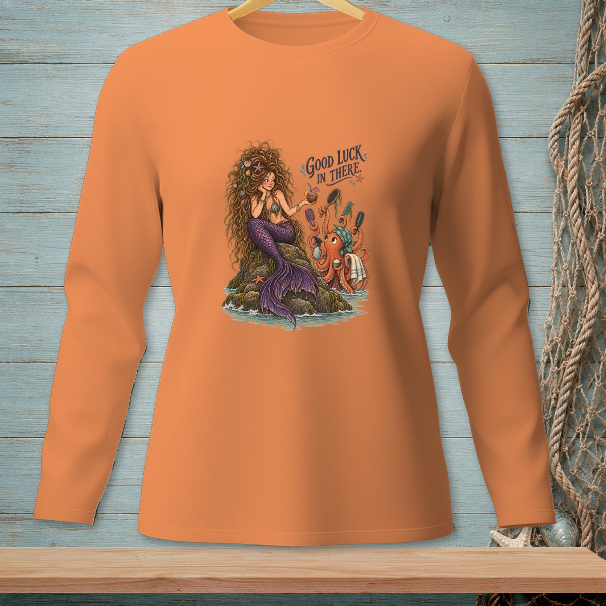 Orange long-sleeve shirt featuring a mermaid and octopus with the text "Good Luck In There."