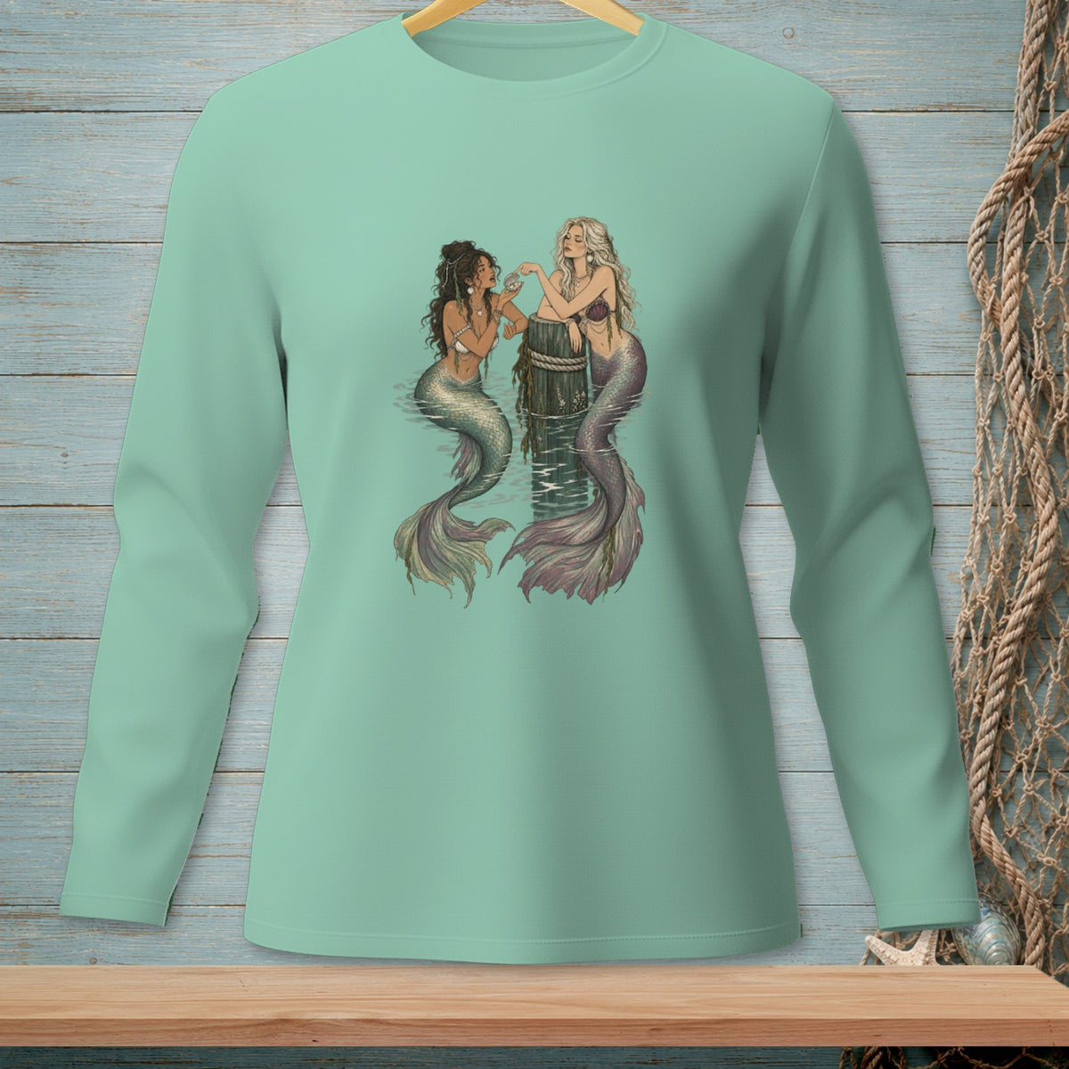 Two mermaids interact near a barnacle-covered post in the water.