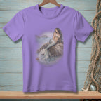 Purple t-shirt with a print of a mermaid sitting on a rock by the sea.
