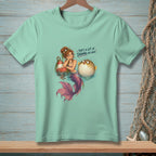 Mermaid with pufferfish and buoy, text reads "That's a lot of drama per inch."