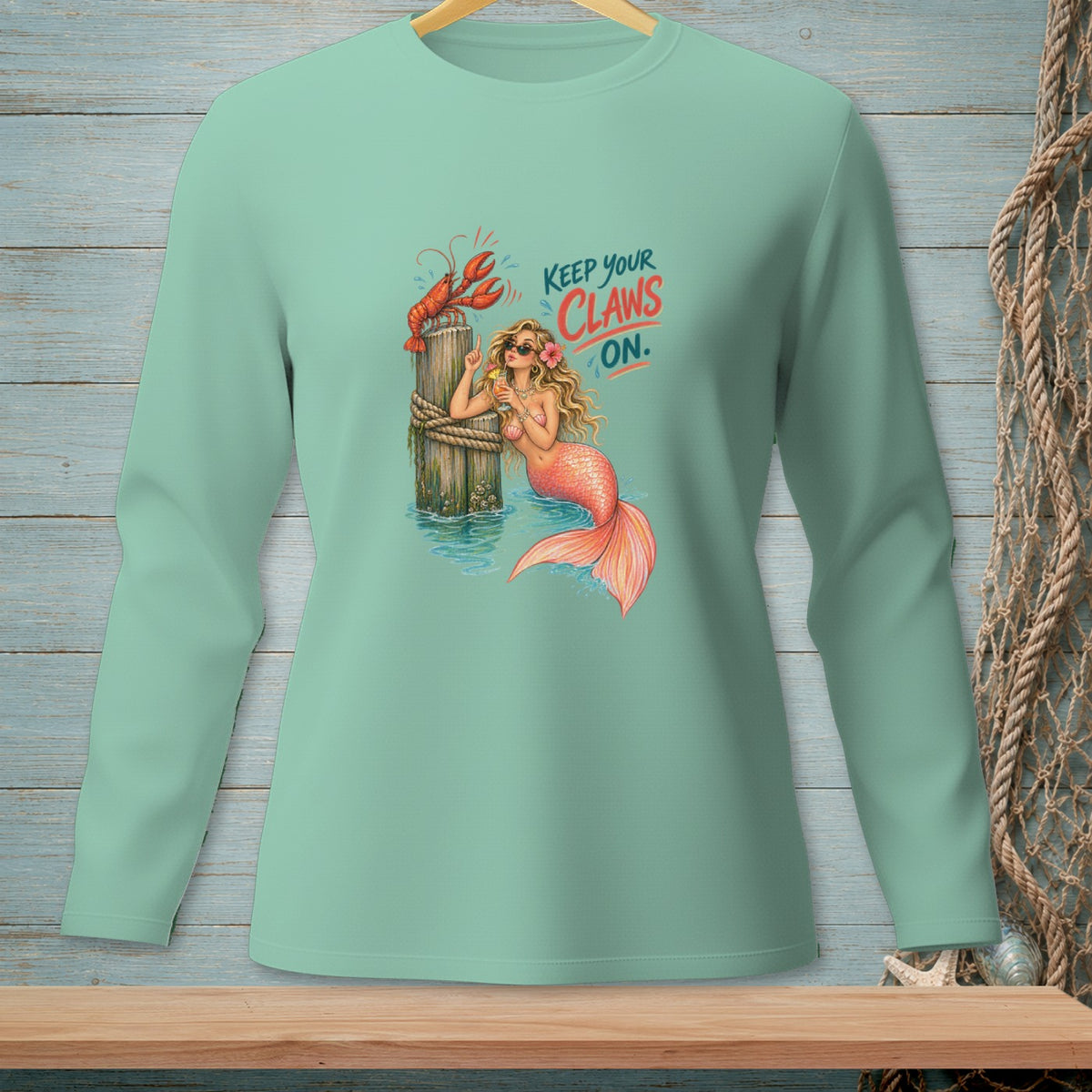Mermaid with a lobster and cocktail on a dock, "Keep your claws on."