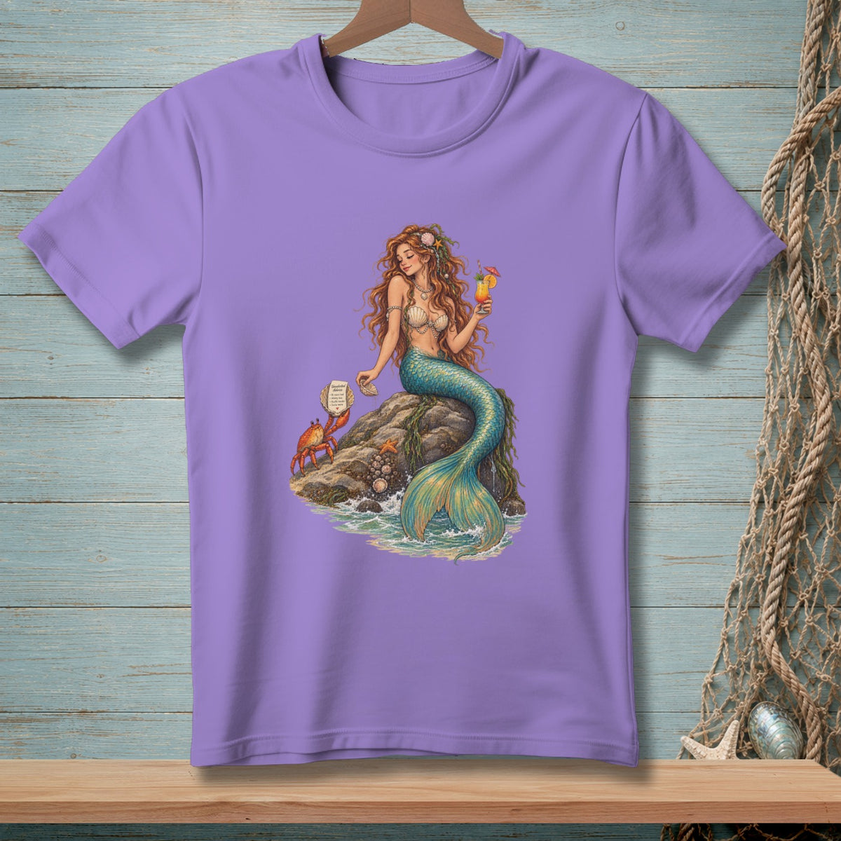 Mermaid with cocktail on rock with crab and seashells, printed on a purple t-shirt.