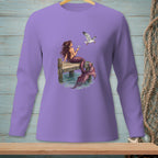 Purple long-sleeve shirt with a mermaid holding a drink on a dock with a seagull.