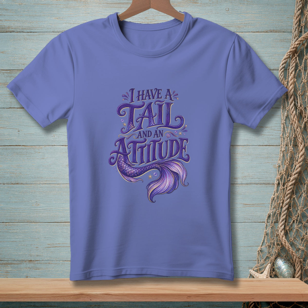 Purple t-shirt with "I have a tail and an attitude" mermaid graphic.