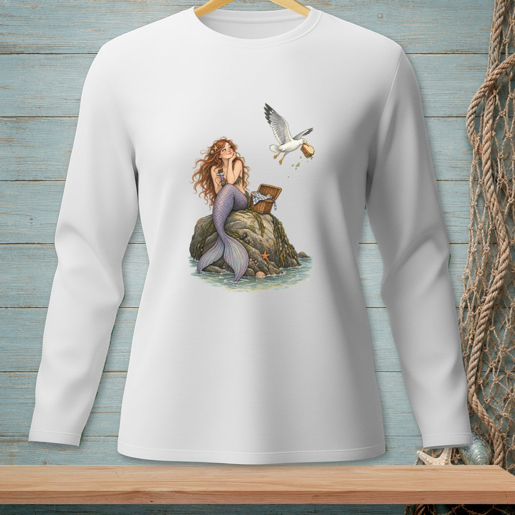 Illustration of a mermaid sitting on a rock while a seagull steals a sandwich from a picnic basket.