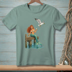 Mermaid with red hair sitting on a dock with a seagull holding food.