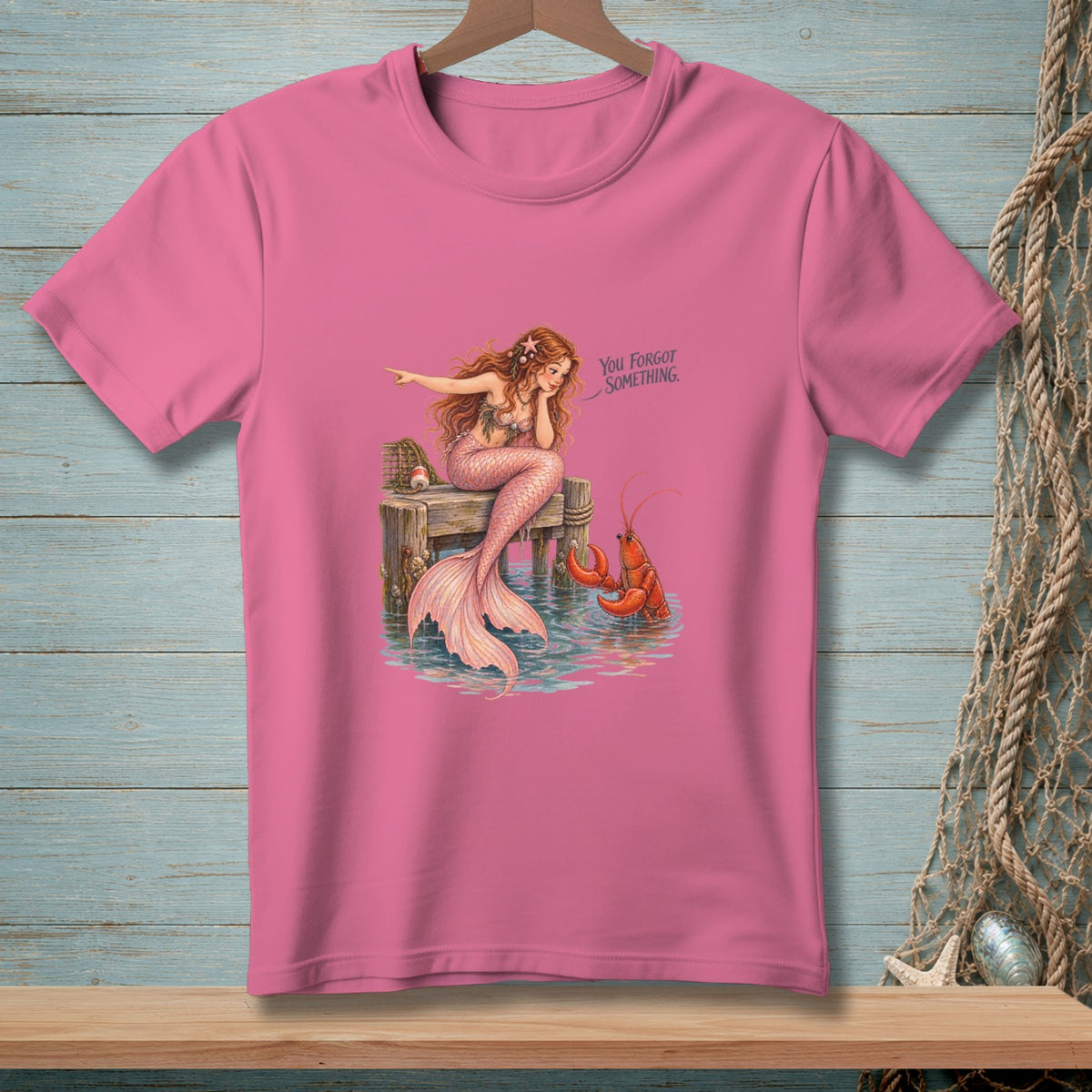 Mermaid on dock with lobster, text reads "You Forgot Something."