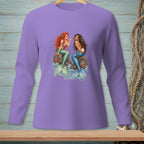 Two mermaids, one with red hair, the other with dark hair, sit on rocks.