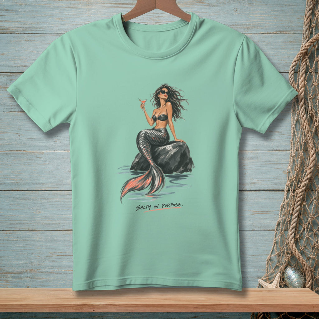Mint t-shirt with a mermaid illustration holding a cocktail, text "Salty on Purpose."