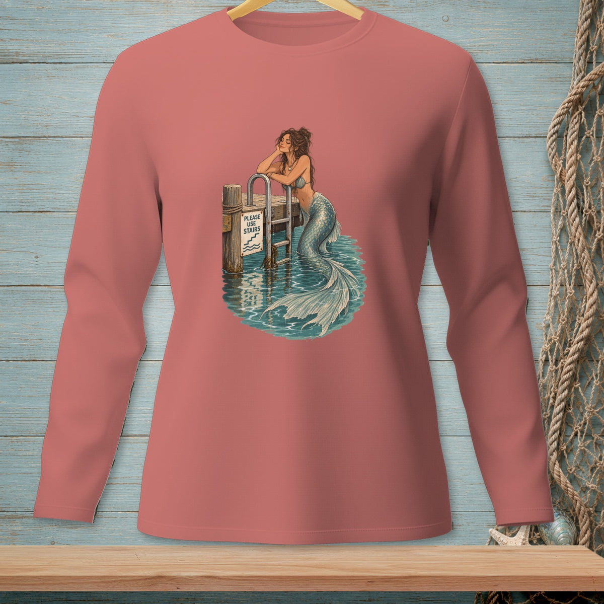 Mermaid resting on dock post with "Please Use Stairs" sign and ladder.