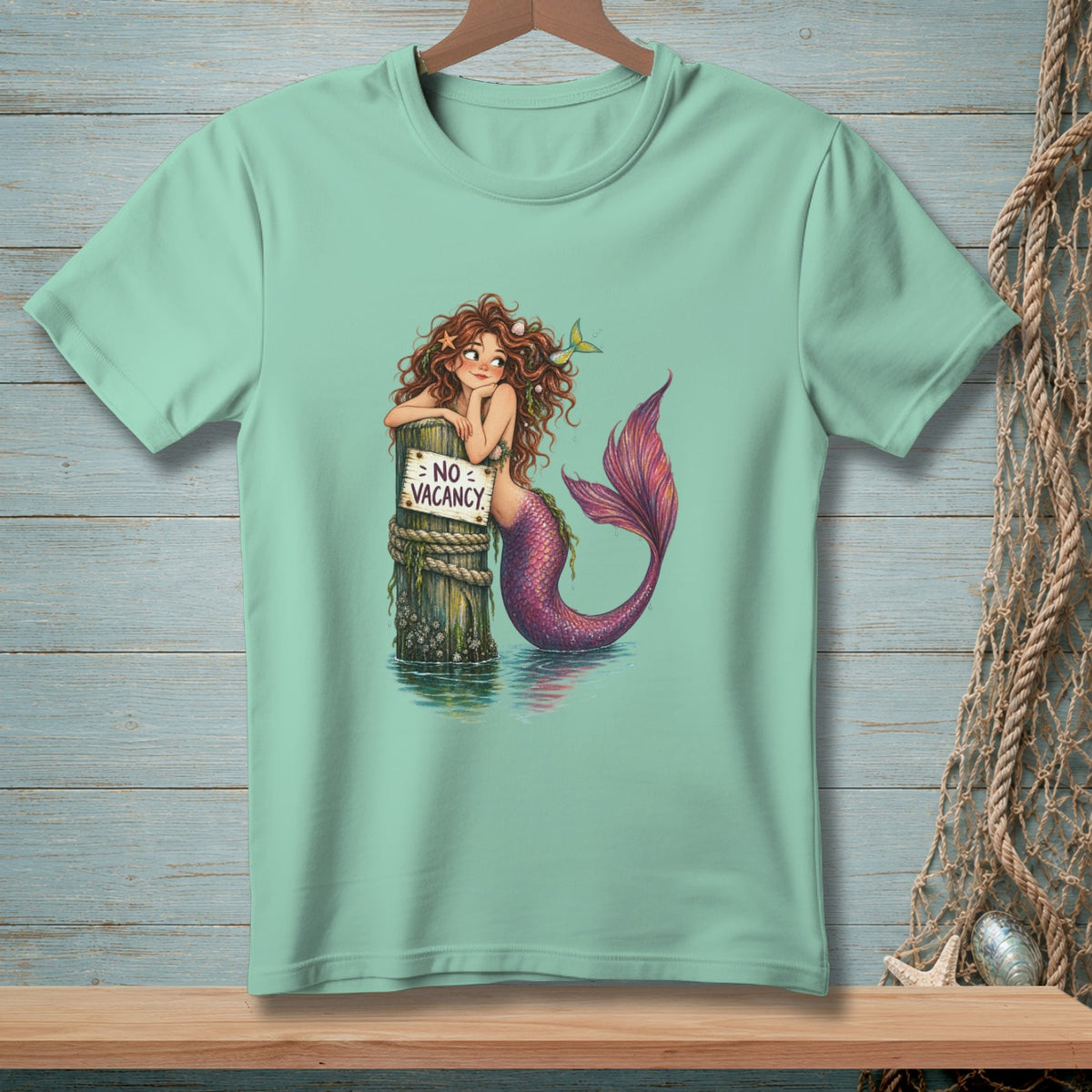 Mermaid leaning on post with "NO VACANCY" sign in the water.