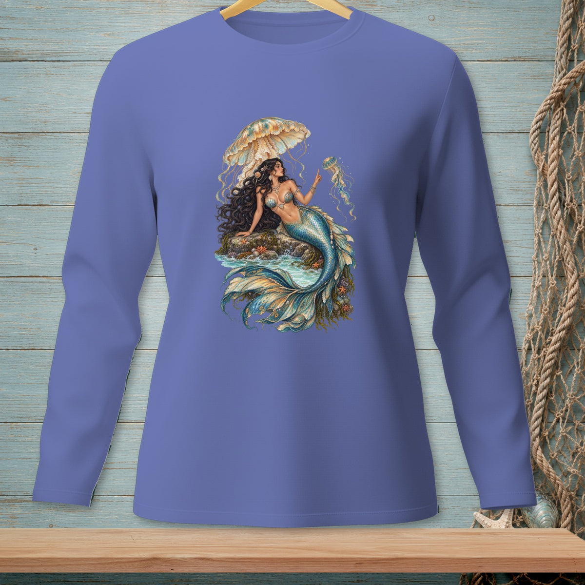 Illustration of a mermaid with jellyfish and umbrella on a purple long-sleeve shirt.