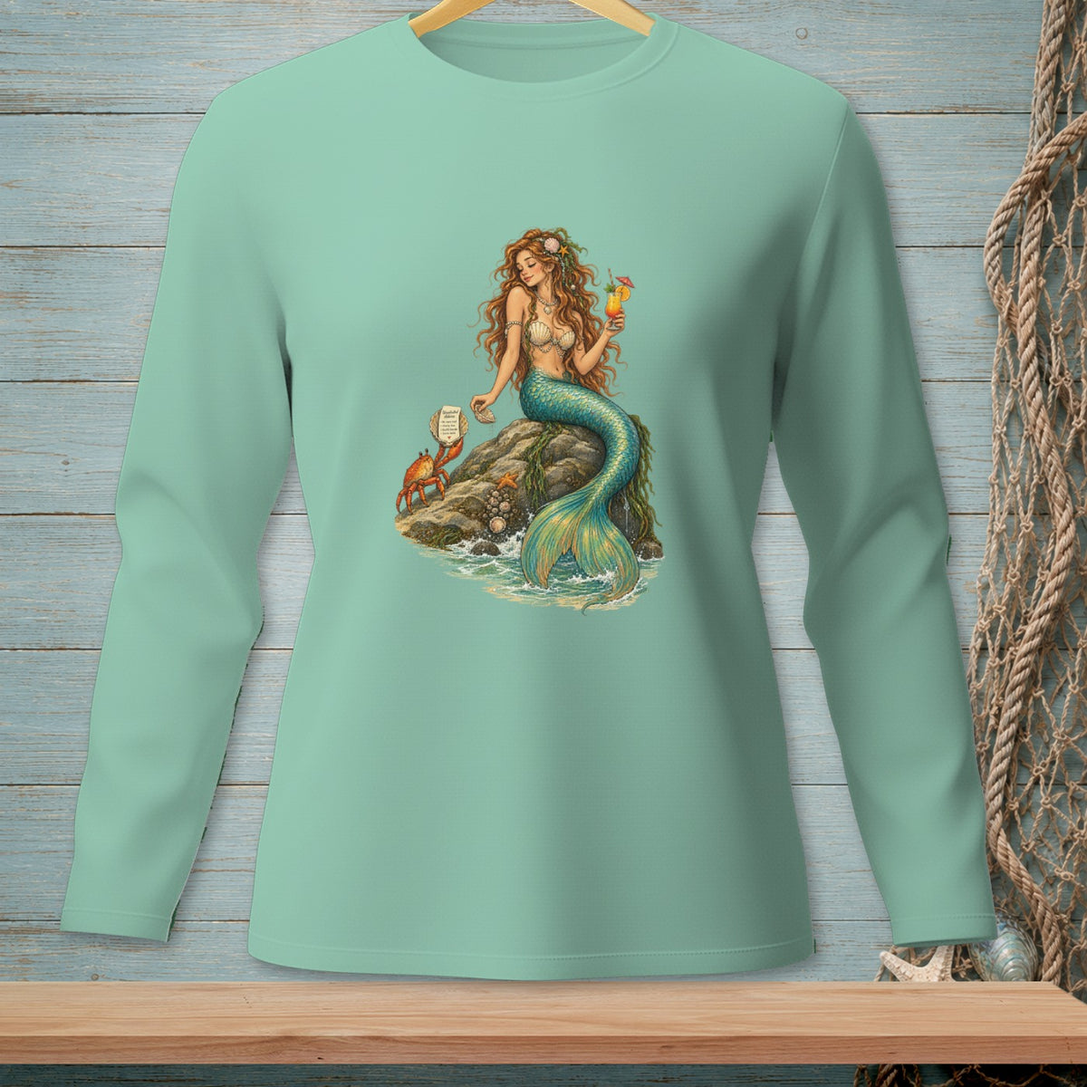Mermaid with drink and crab on rock, with text on a scroll.