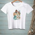 White t-shirt with a graphic of three mermaids having a party on a table.