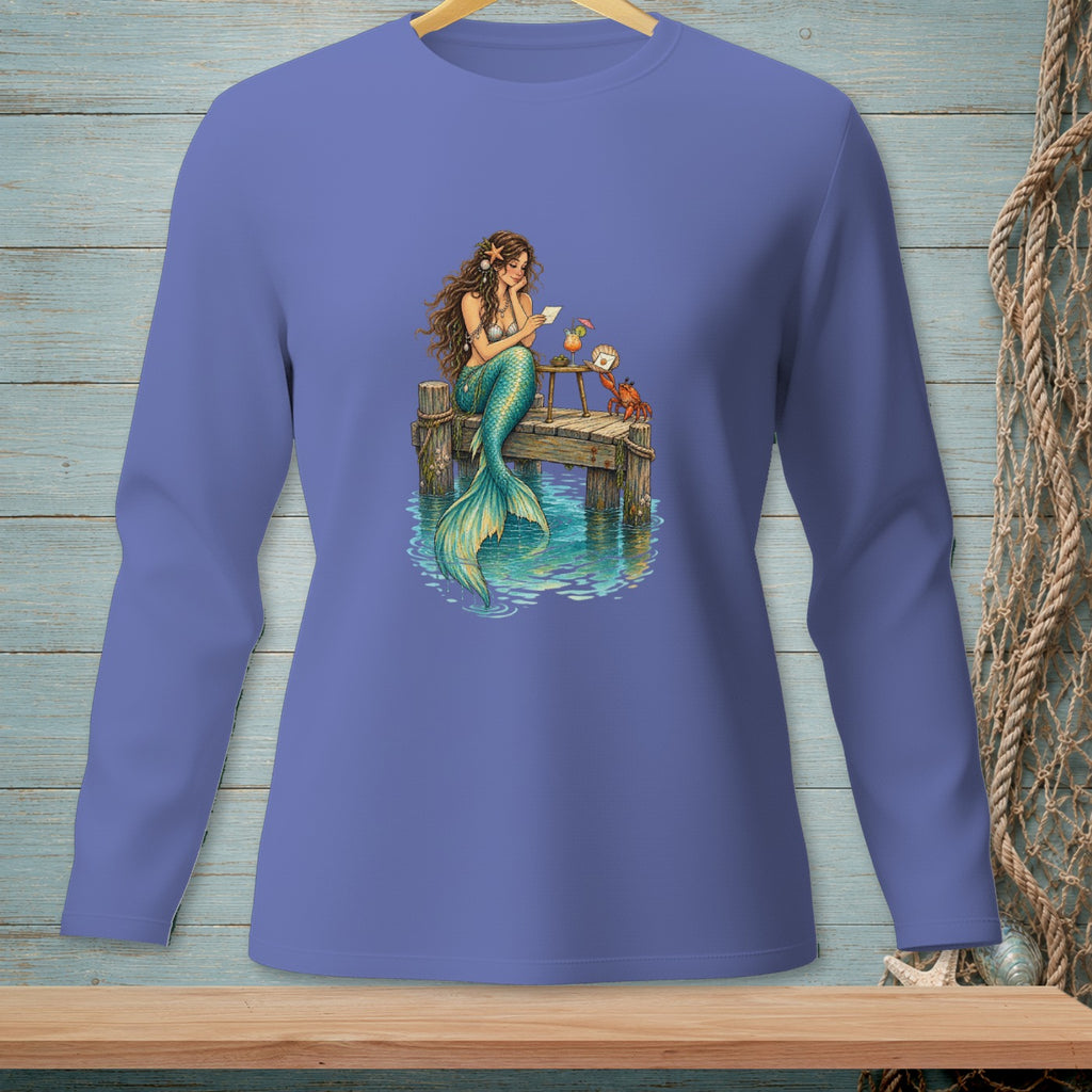 Mermaid reading letter on dock with crab and cocktail.
