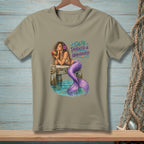 Mermaid with purple tail drinks from coconut on pier, text "Salty, Tangled & Unbothered."