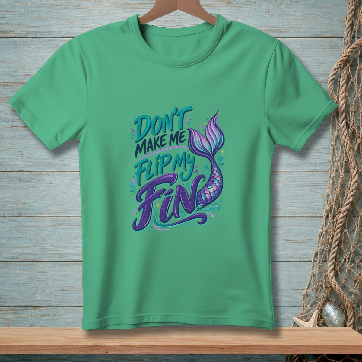 Green t-shirt with purple and teal text reading "Don't make me flip my fin" and a mermaid tail.