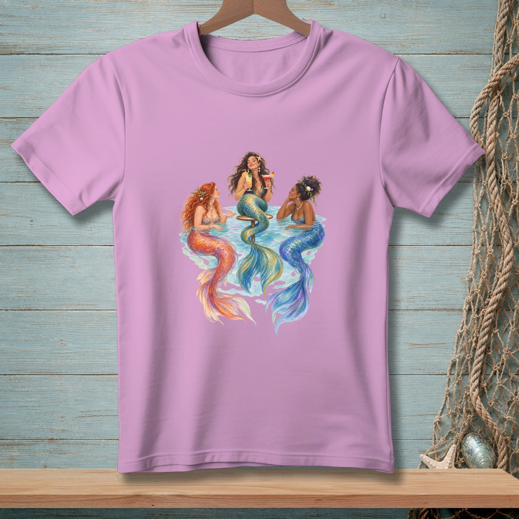 Three mermaids with colorful tails relax and drink cocktails in the water.