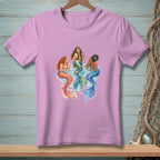 Three mermaids with colorful tails relax and drink cocktails in the water.