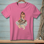 Pink t-shirt with a seated mermaid on a rock in waves graphic.