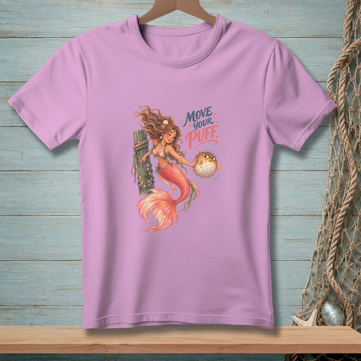 Lilac t-shirt with mermaid holding pufferfish and text "Move Your Puff."