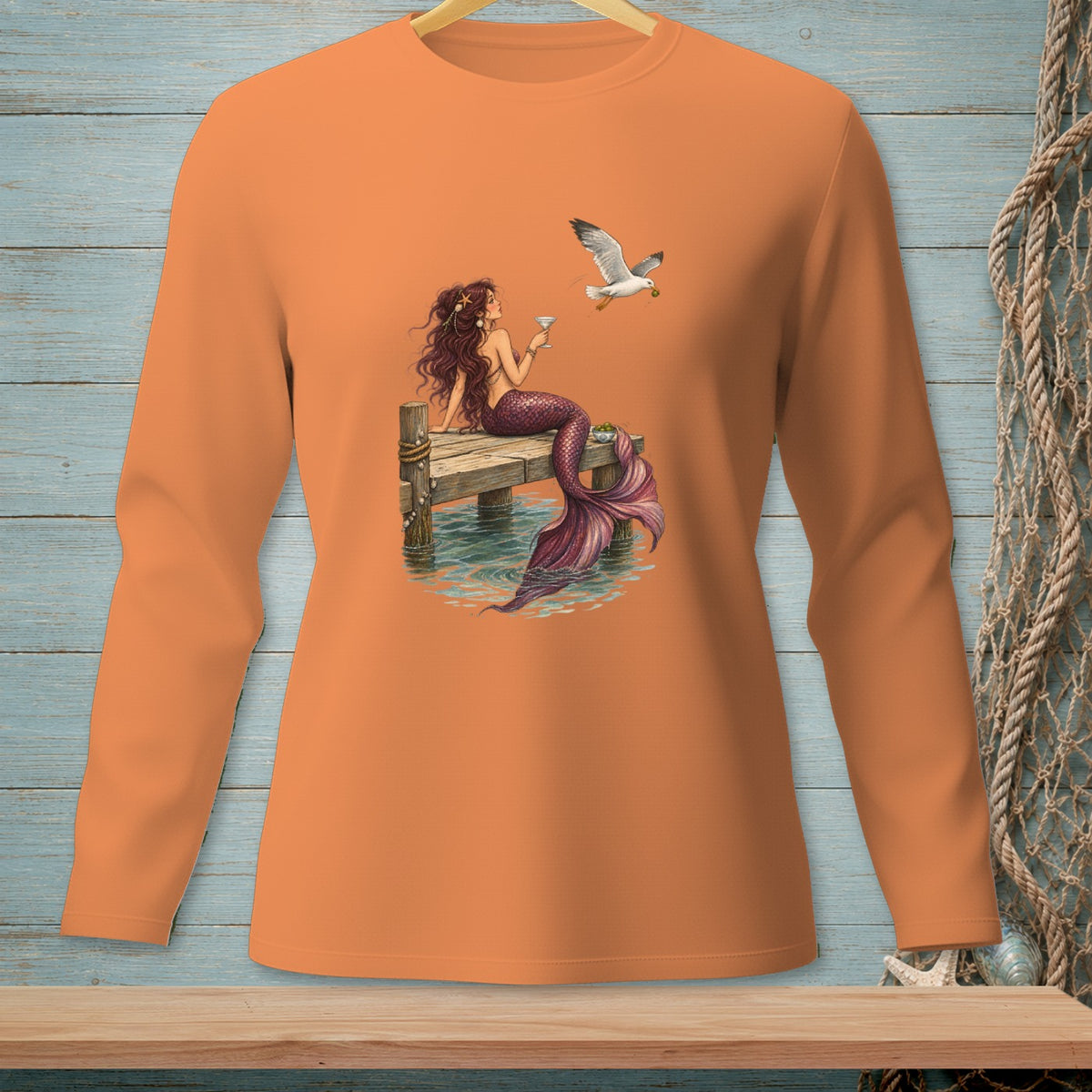 Mermaid with a drink and a seagull on a pier.