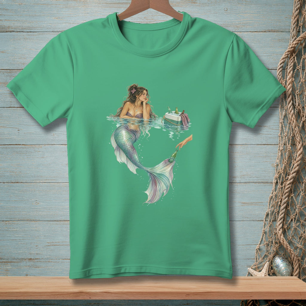 Mermaid reaching for a beer from a cooler in water with a beach background.