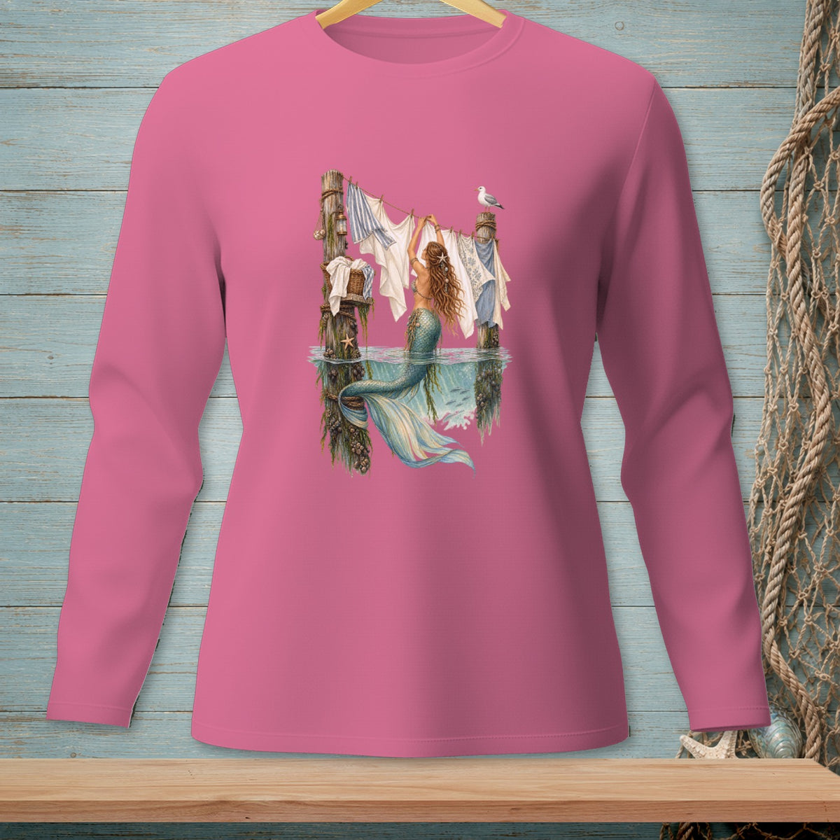 Mermaid hanging laundry on a clothesline with a seagull perched above.