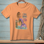 Peach t-shirt with mermaid artwork and "Sea Hair Zero Care" text.