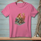 Pink t-shirt with mermaid and octopus artwork showing a mermaid looking in a seashell mirror.