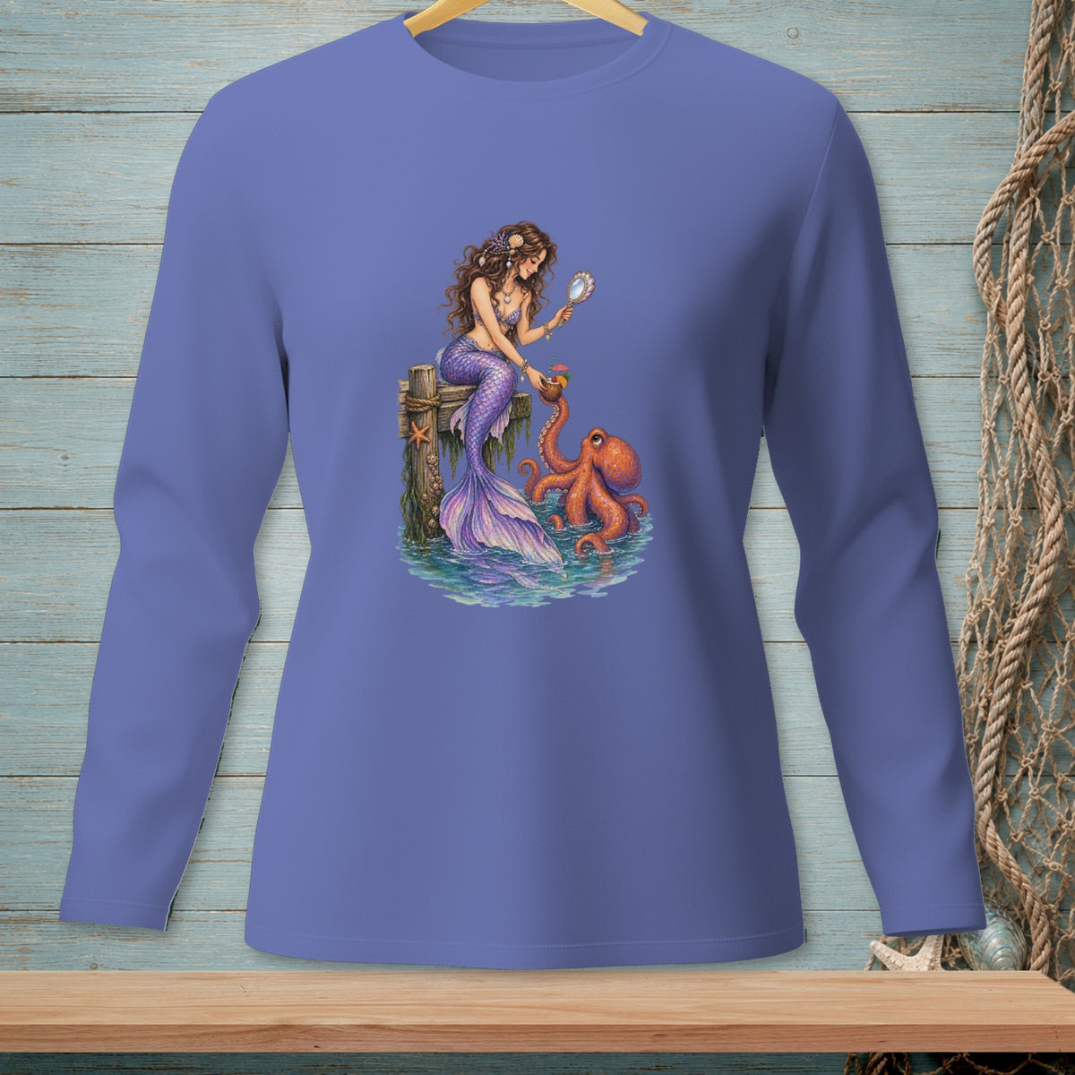 Mermaid holding mirror with octopus by a wooden pier on a long-sleeved shirt.