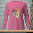 Three mermaids with colorful tails relax in water with drinks on a pink long-sleeve shirt.