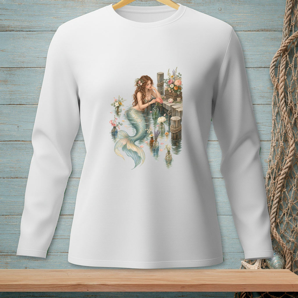 White long-sleeve shirt with a watercolor mermaid and flowers on a dock.