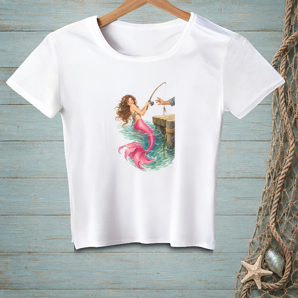 White t-shirt with a graphic of a mermaid fishing from a dock.